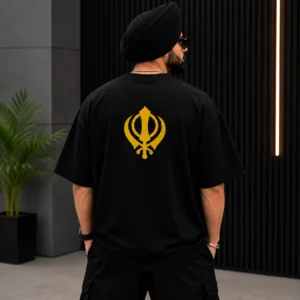 Sardar model wearing black oversized t shirt with large yellow Khanda back print
