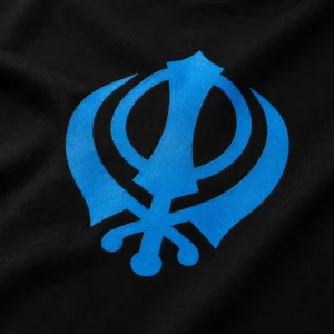 Close-up view of blue Khanda logo on black oversized Punjabi t shirt