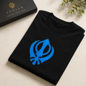 Folded black oversized t shirt with blue Khanda Sikh symbol on light luxury background