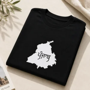 Folded black oversized t shirt with white Punjab map Punjabi print on light background