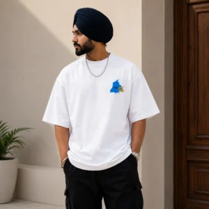 Punjabi Sikh model wearing white oversized t shirt with Punjab wheat front logo design